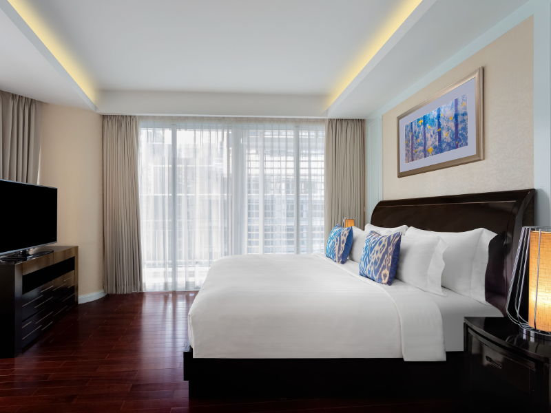 Spacious suite at Dusit Suites Ratchadamri Bangkok with a separate bedroom and living area.