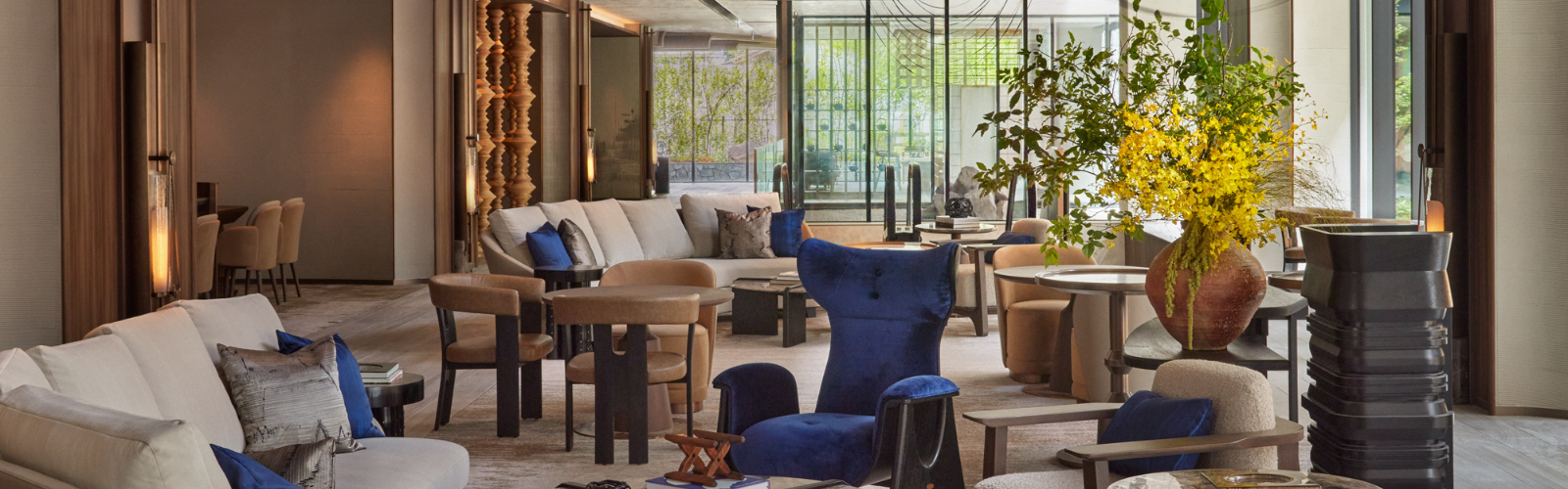 Welcoming hotel lobby with a large floral arrangement and front desk